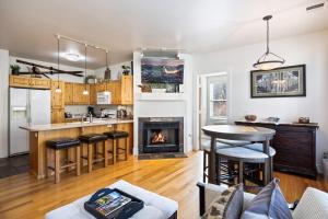 a kitchen and living room with a fireplace at Summit Sanctuary, Sleeps 4, Charming Interiors, 20 Minutes from the Mountain! in Gorgosa