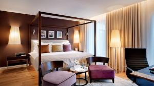 a hotel room with a bed and a table and chairs at B&B HOTEL RZESZÓW CENTRUM in Rzeszów