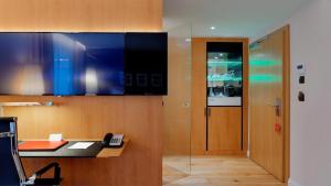 an office with a desk with a phone and a door at B&B HOTEL RZESZÓW CENTRUM in Rzeszów