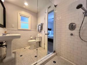 a bathroom with a shower and a toilet and a sink at Destination #13 in Anaheim +22 photos