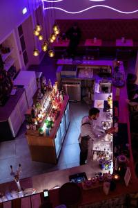a man standing at a counter in a purple room at Siglo Hotel by Keahotels in Siglufjörður