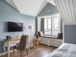 a bedroom with a bed and a desk and a window at Siglo Hotel by Keahotels in Siglufjörður +51 photos