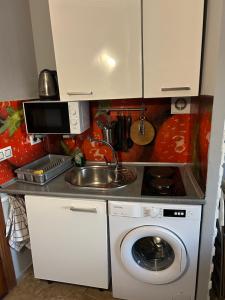 a kitchen with a sink and a washing machine at Denia Playa I in Denia