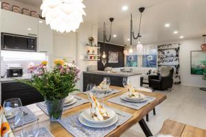 a kitchen and living room with a table with dishes on it at Vasko Luxurious Suites, Firefox in Rovaniemi