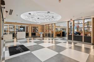 a view of a store lobby with a checkerboard floor at Kompose Boutique Hotel Houston Cy-Fair in Houston +25 photos