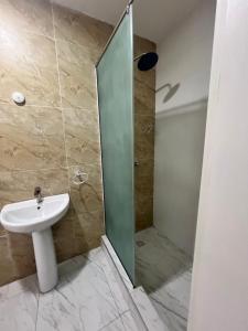 a bathroom with a sink and a shower at Glides studio in Lekki
