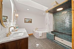 a bathroom with a tub and a sink at Sit Stay Play in Beech Mountain +39 photos
