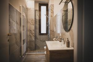 a bathroom with a sink and a mirror at Casamè Apartment Sulmona - a due passi da centro, free bike park in Sulmona