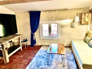 a living room with a couch and a table at L'escalier gaucher in Lambesc
