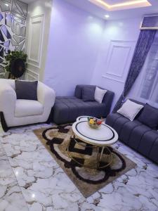 a living room with a couch and a table at Yinmic Homes in Ikorodu