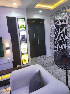 a living room with a white bed and a couch at Yinmic Homes in Ikorodu