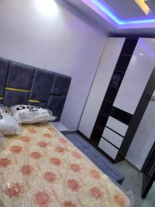 a bedroom with a bed with a black head board at Yinmic Homes in Ikorodu
