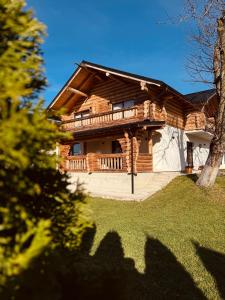 a log house with a porch and a deck at Cabana 9 in Borşa