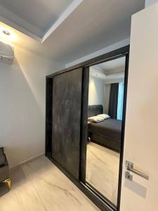 a mirror in a room with a bed in a bedroom at Cebeci tower in Mahmutlar +9 photos