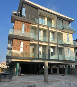 a tall brick building with balconies on it at Smartlinks apartments in Ikota