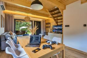 Un comedor con una mesa con una computadora portátil encima. en Dream Home 600m2 EV WiFi600 PlaySt Kominek Las10min, en Polanica-Zdrój