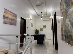 a hallway with a pool table in a room at City Escape in Ikota +7 photos