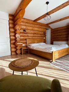 a bedroom with a bed in a log cabin at Cabana 9 in Borşa