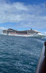 a large cruise ship in the ocean on the water at excelente localização o mar na sua frente confira in São Vicente