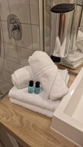 a pile of towels sitting on a counter next to a sink at Waldhotel Bad Essen in Bad Essen