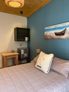 a bedroom with a large bed and a tv at Las Olas Miramar in Miramar