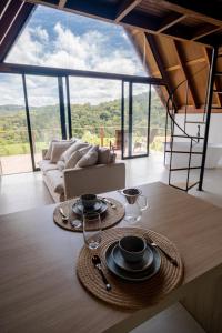 a living room with a table with plates and glasses on it at Serra e Sossego in Annitapolis