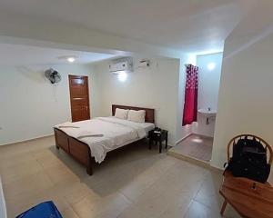 a bedroom with a bed and a red curtain at Villa funk monk - swimming pool in Kuilapayam