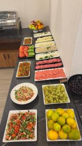 a table full of different types of vegetables and fruits at Gnc Airport Hotel in Arnavutköy