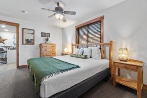 a bedroom with a bed and a ceiling fan at The Loose Moose Lodge #7 At Downtown Grand Lake N in Grand Lake