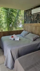 ein Schlafzimmer mit zwei Betten und einem Fenster in der Unterkunft Rancho Flamboyant Lazer in Lajeado