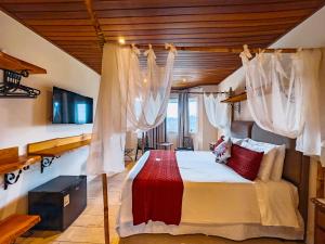 Postel nebo postele na pokoji v ubytování Pousada Ville Le Mont - Campos do Jordao