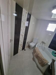 a bathroom with a tub and a toilet and a sink at Ferienwohnung Nabeul in Douane +12 photos