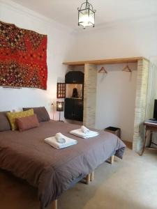 a bedroom with a bed with two towels on it at el rinconcito in Sanlúcar de Barrameda