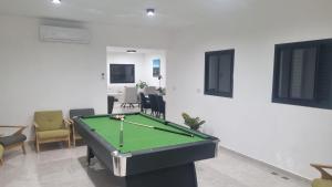 a living room with a pool table in it at Vista royal golan in Ein Kinya