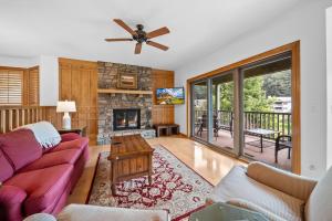 a living room with a couch and a fireplace at Chetola: Sierra 1 in Blowing Rock