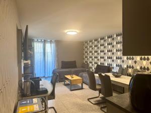 a living room with a bed and a couch at Hotel "Mythos Apartments" alle Zimmer mit Kochnische, Apartments mit Küche! in Markgröningen