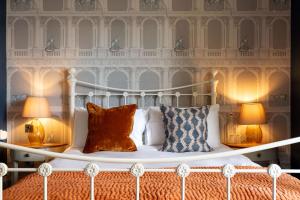 a bedroom with a white bed with two lamps at The Westgate in Winchester