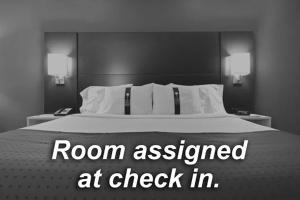 a bedroom with a bed with a room assessed at check in at Holiday Inn Express and Suites Dimondale-Lansing 