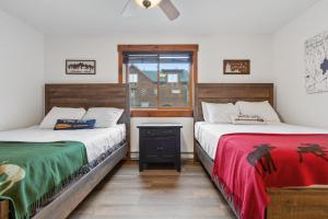 two beds sitting next to each other in a room at The Loose Moose Lodge #4 At Downtown Grand Lake in Grand Lake