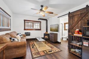a living room with a couch and a ceiling fan at The Loose Moose Cabin #9 At Downtown Grand Lake in Grand Lake