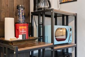 a shelf with a television and a bottle on it at The Loose Moose Cabin #10 At Downtown Grand Lake in Grand Lake