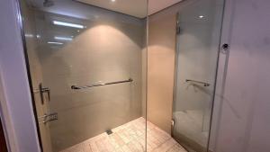 una ducha con puerta de cristal en un baño en Luxury Waterfront Studio with Canal Views, en Ciudad del Cabo 26 fotos más