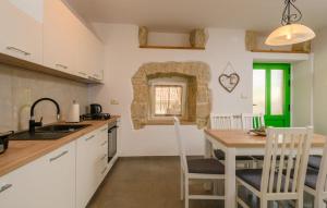 a kitchen with a table and a dining room at House Casa Della Nonna in Kršan +14 photos