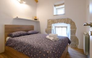 a bedroom with a bed with two towels on it at House Casa Della Nonna in Kršan