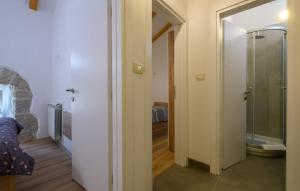 a hallway with a walk in shower and a glass door at House Casa Della Nonna in Kršan