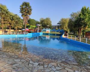 a large pool of water in a theme park at La Maison du soleil L Aulhere 3 étoiles ,Maison familiale 6-7 personnes, Grand Jacuzzi 6 p , Repas traiteur et massages bien-être en option in Oloron-Sainte-Marie