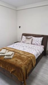 a bedroom with a large bed with blankets and pillows at CercIbis in Chişinău