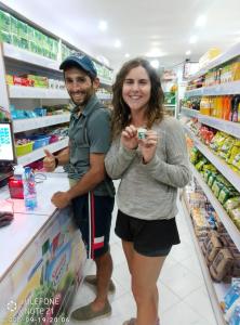 a man and a woman standing in a supermarket at Homebase gardens homestay in Nakuru