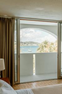 a bedroom with a large window with a view of the ocean at Hotel on the Cay in Christiansted