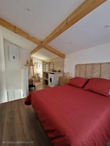 a bedroom with a red bed and a kitchen at Duplex design in Archamps